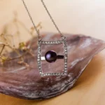 Collier argenté rectangulaire serti, avec perle violette centrale