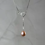Collier argenté à doubles cœurs et perle rose pendante